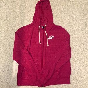 Women’s medium pink zip up Nike sweater.